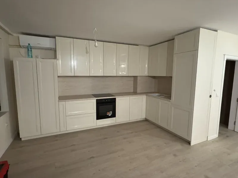 Large cream gloss kitchen with classic profiled doors