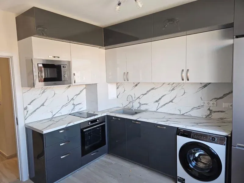 Grey and white kitchen with a marble-effect splashback