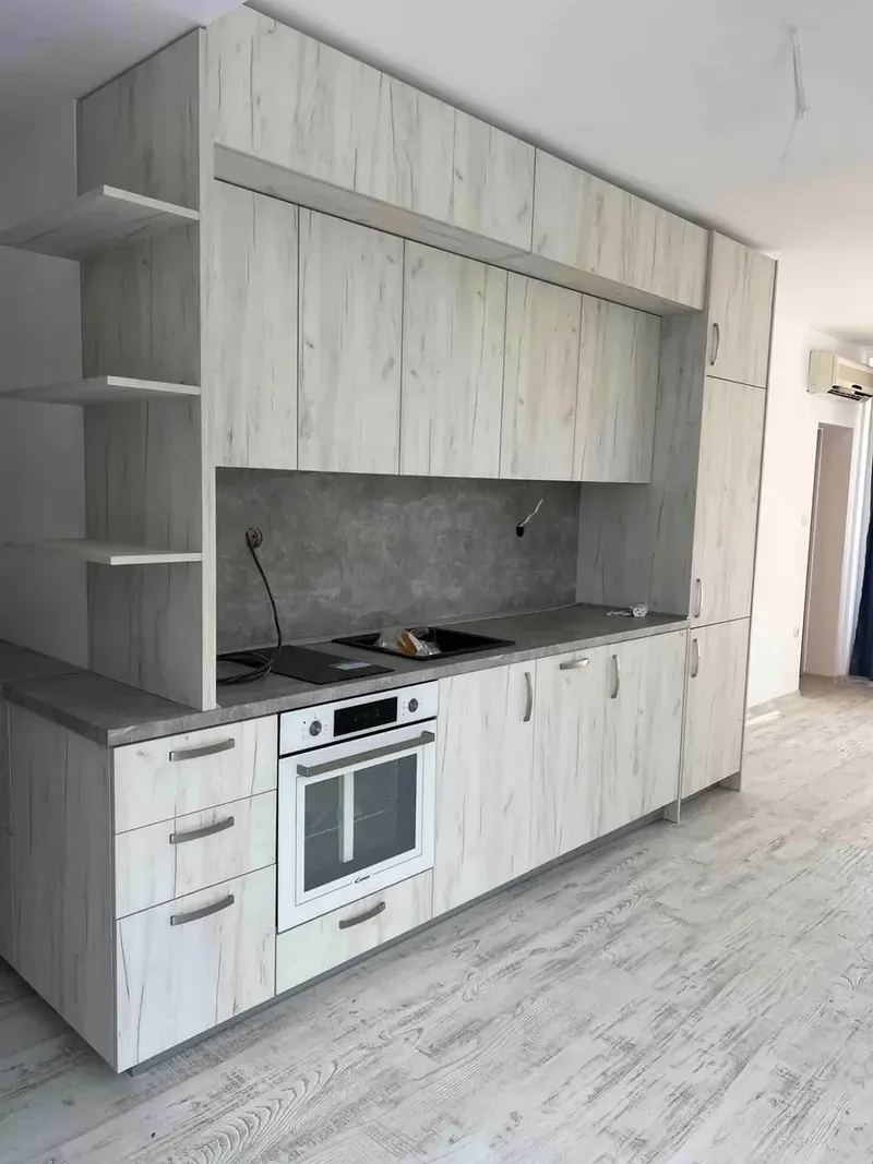 Light oak kitchen running to the ceiling with open shelving
