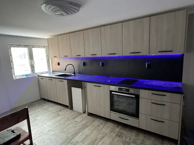 Oak and grey kitchen with LED under-cabinet lighting