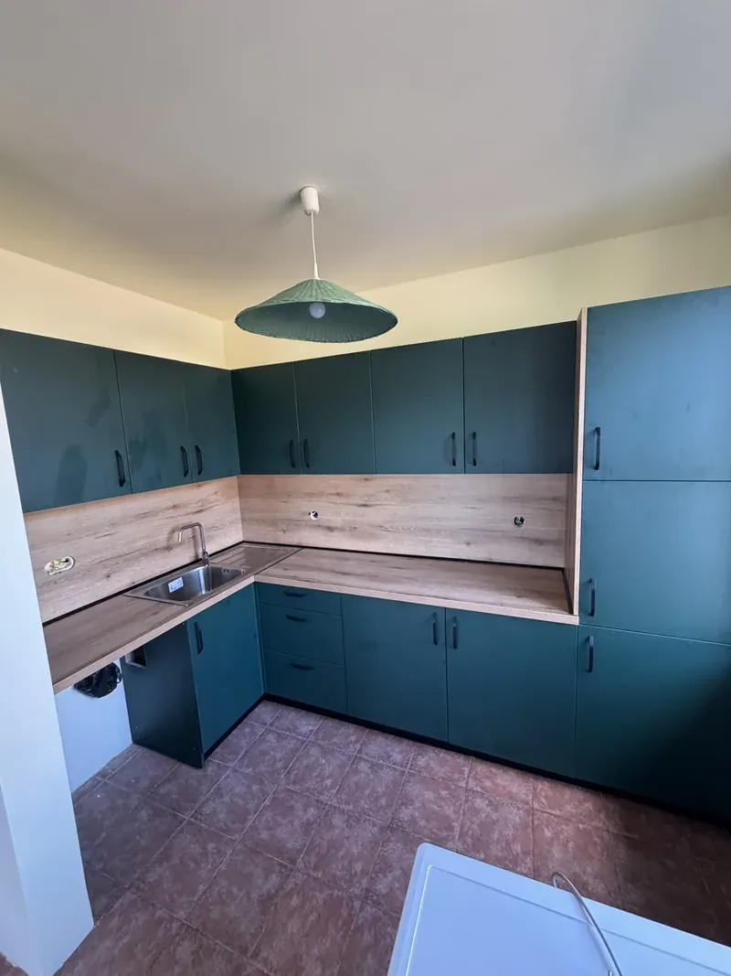 Petrol green kitchen with dark wood worktop