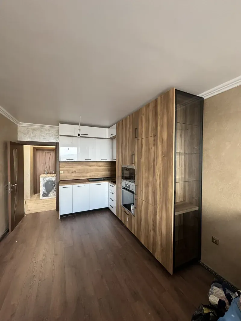 White kitchen with a walnut glass-fronted display unit