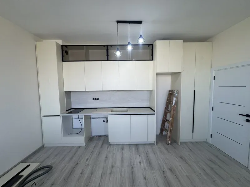 White kitchen with tall units and a central island